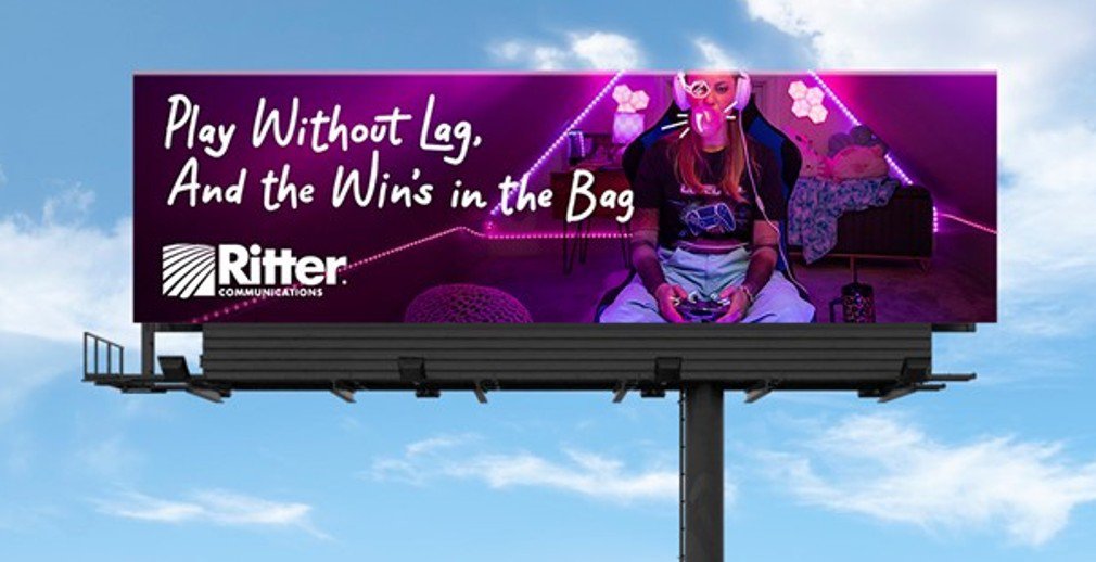 a billboard with a woman playing video games. Billboard Inventory Access